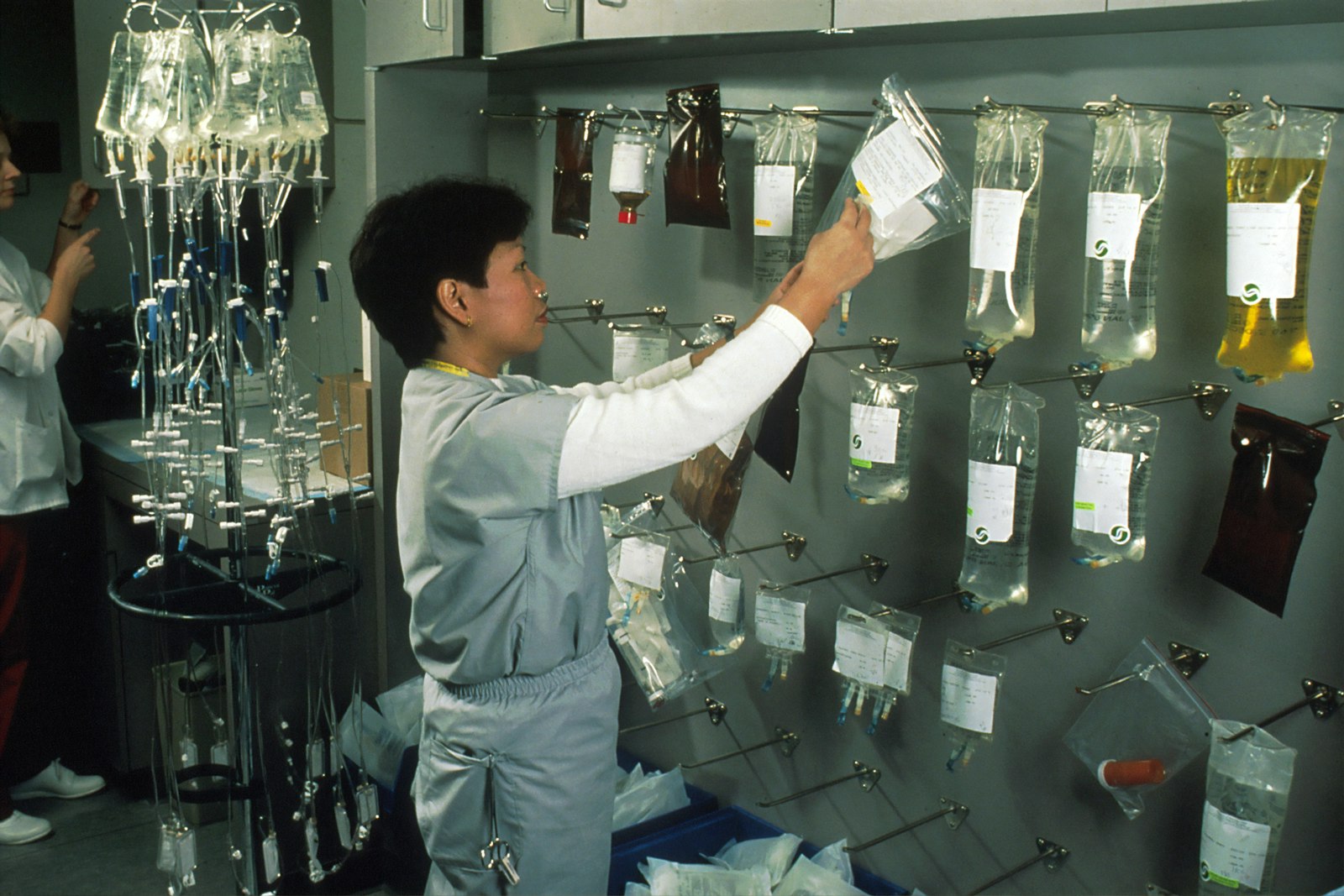 A clinician arranging IV bags